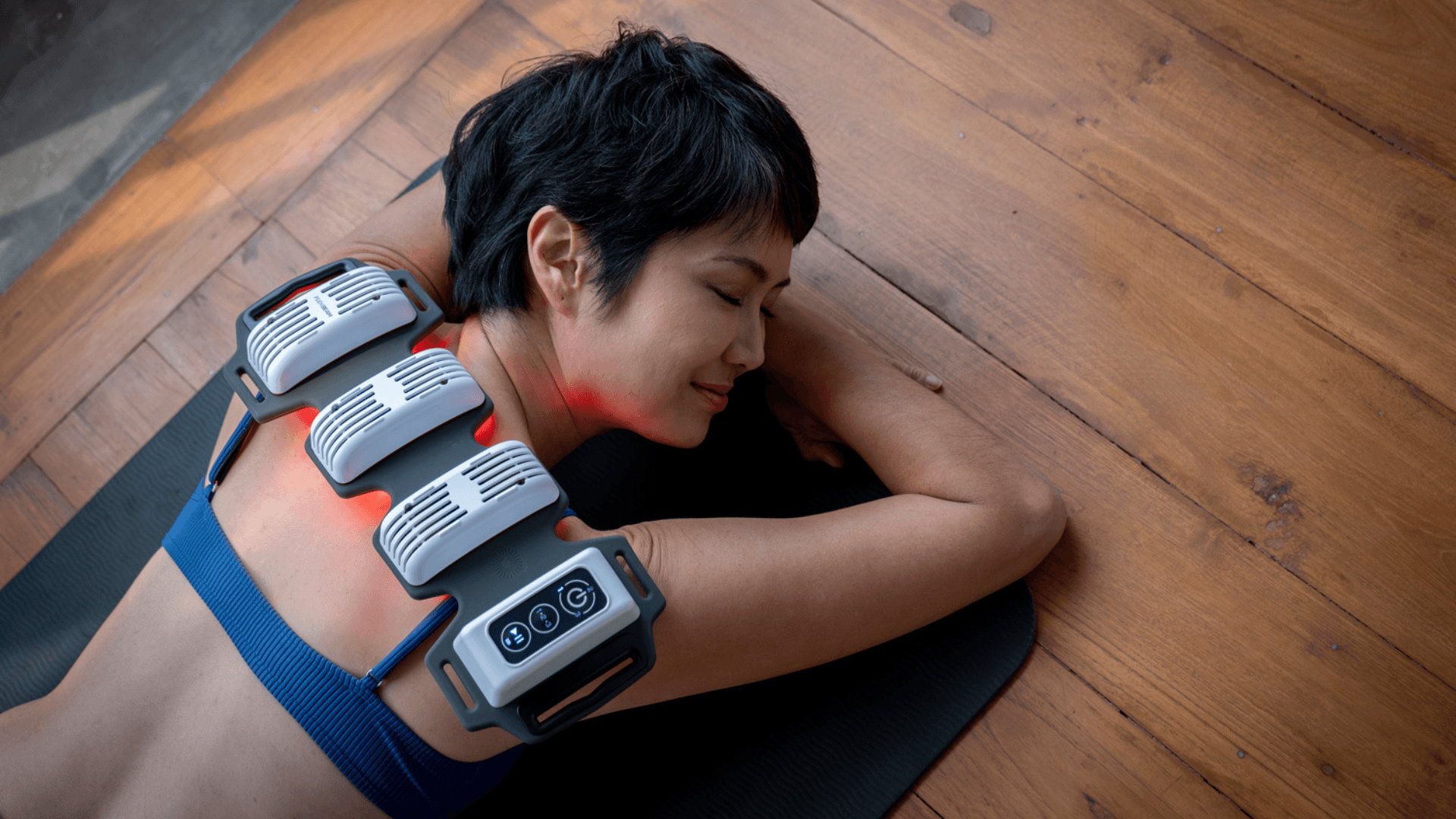 A photo of someone using red light therapy to help their body relax.