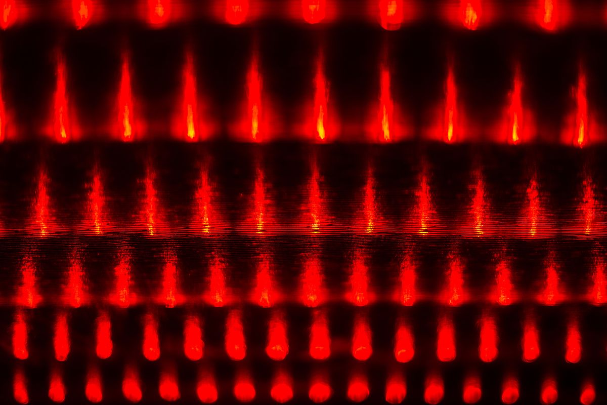 a series of red lights shine against a dark background