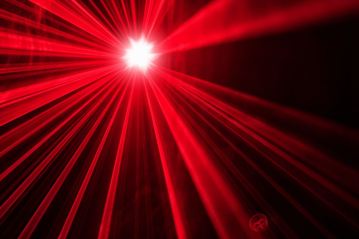 a bright red light shines, with rays spreading around it