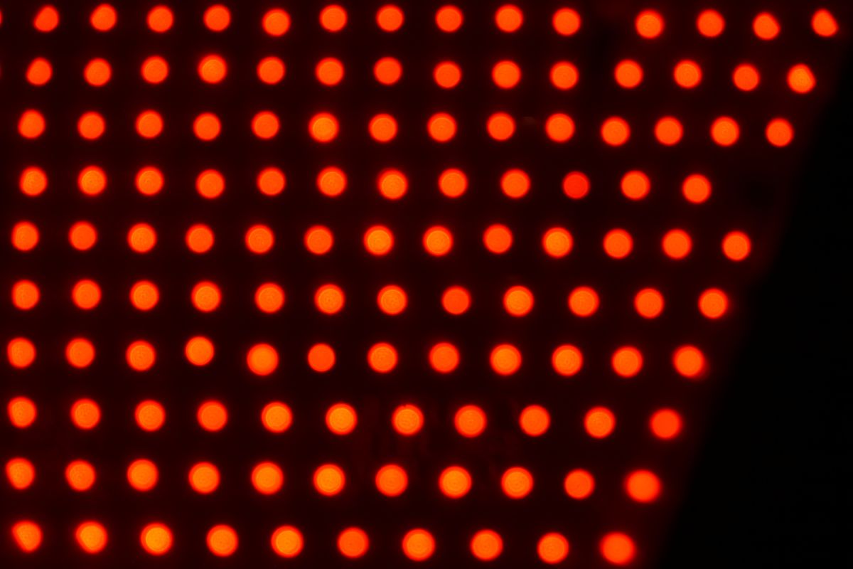 a series of red lights can be seen against a black background